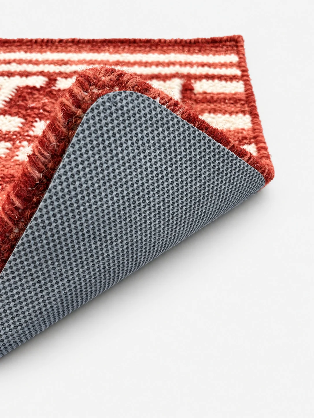 Classic Base rug pad shown beneath a folded area rug