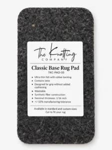 Classic Base rug pad shown beneath a folded area rug