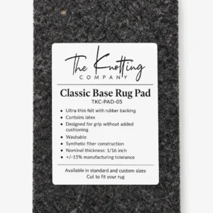 Classic Base rug pad shown beneath a folded area rug